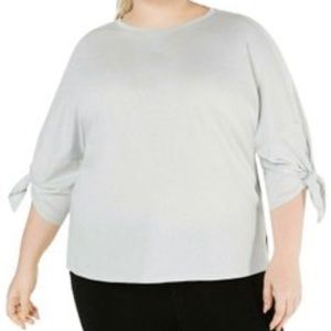 Calvin Klein 3/4 lightweight sleeve performance top tied on the forearm